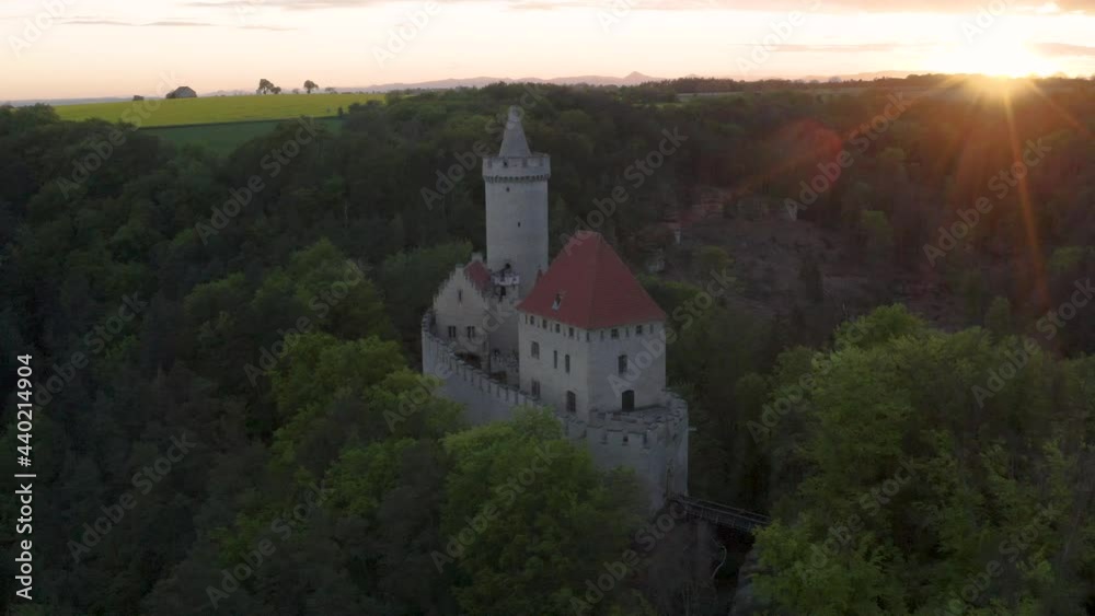 Medieval Kokořín castle in forests of Czechia at sunset,aerial scenery. Medieval Kokořín castle in forests of Czechia at sunset,aerial scenery.