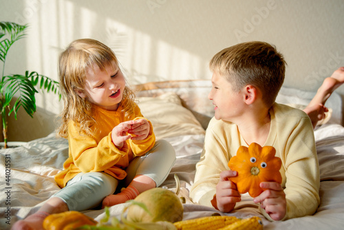 child plays at home on the bed, autumn lifestyle.