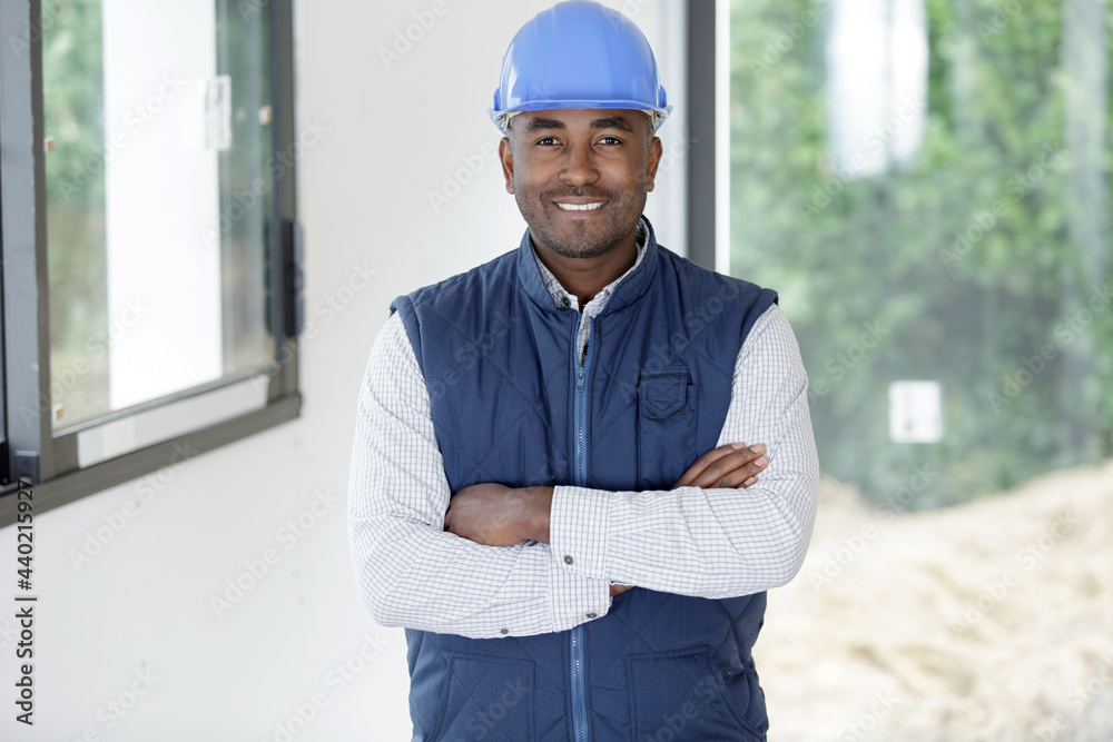 young workman with helmet keeping the arms crossed young workman with helmet keeping the arms crossed