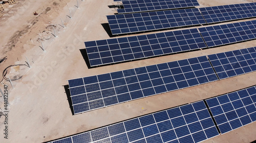 Aerial view of close up solar power panels, in desert.