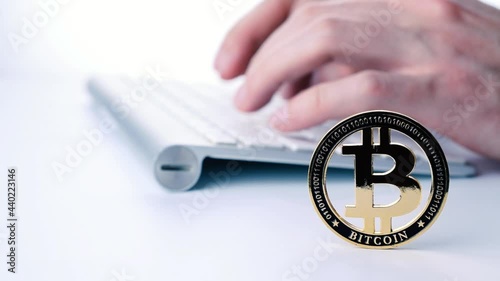 Bitcoin business. Gold Crypto currency BTC Bitcoin with keyboard on white background. Golden Bit Coin virtual cryptocurrency or blockchain technology. Virtual money and mining concept