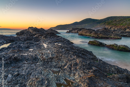 Canvastavla Sunrise seascape and a rocky beach
