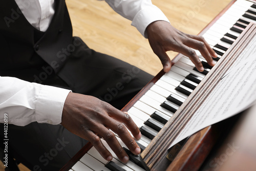Vászonkép African-American man playing piano indoors, closeup