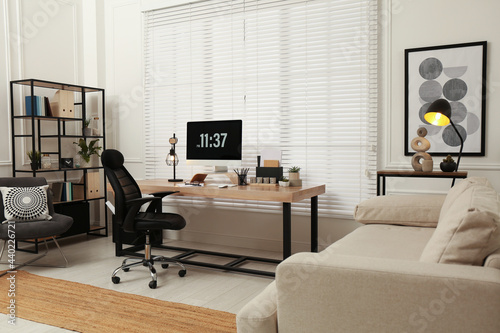 Home office interior with comfortable workplace near window