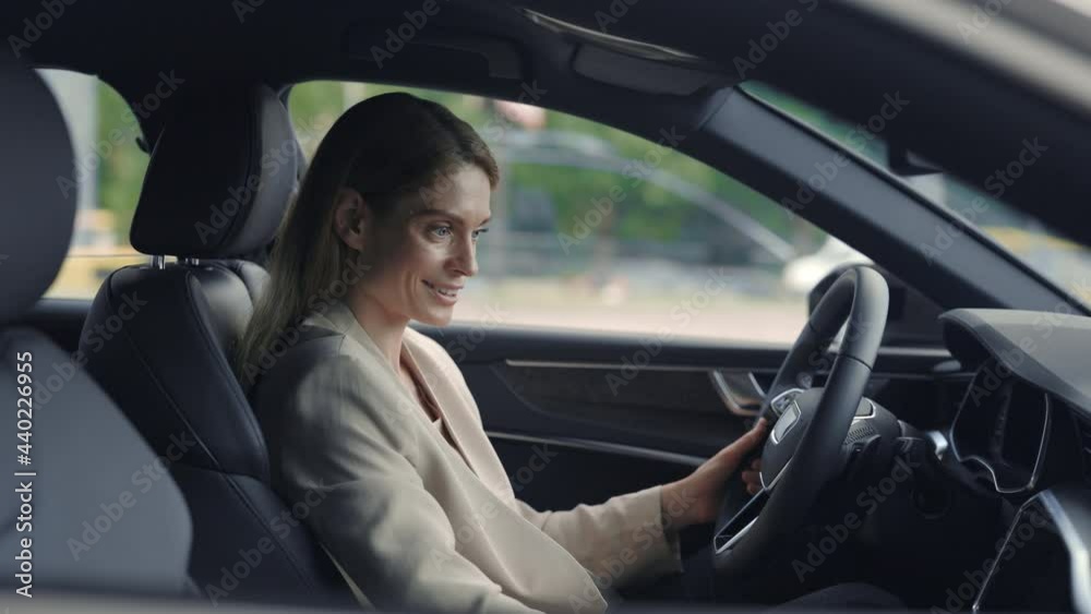 Female client sitting in new car and touching all details Female client sitting in new car and touching all details