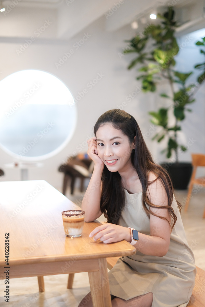 Portrait of Asian woman smiling in coffee shop cafe vintage color tone Portrait of Asian woman smiling in coffee shop cafe vintage color tone