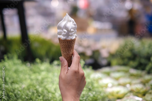 Young woman hands holding ice cream cones on summer , vanilla ice cream cone