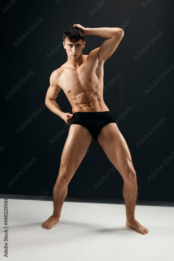 man with a pumped-up muscular body black panties posing dark background man with a pumped-up muscular body black panties posing dark background