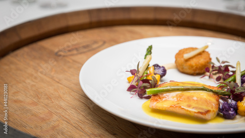 Fotografie Closeup shot of deliciously cooked fish on a white plat