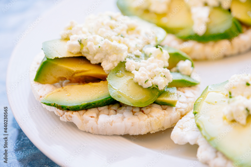 Breakfast of puffed wheat toast with avocado and fresh cheese. Breakfast of puffed wheat toast with avocado and fresh cheese.