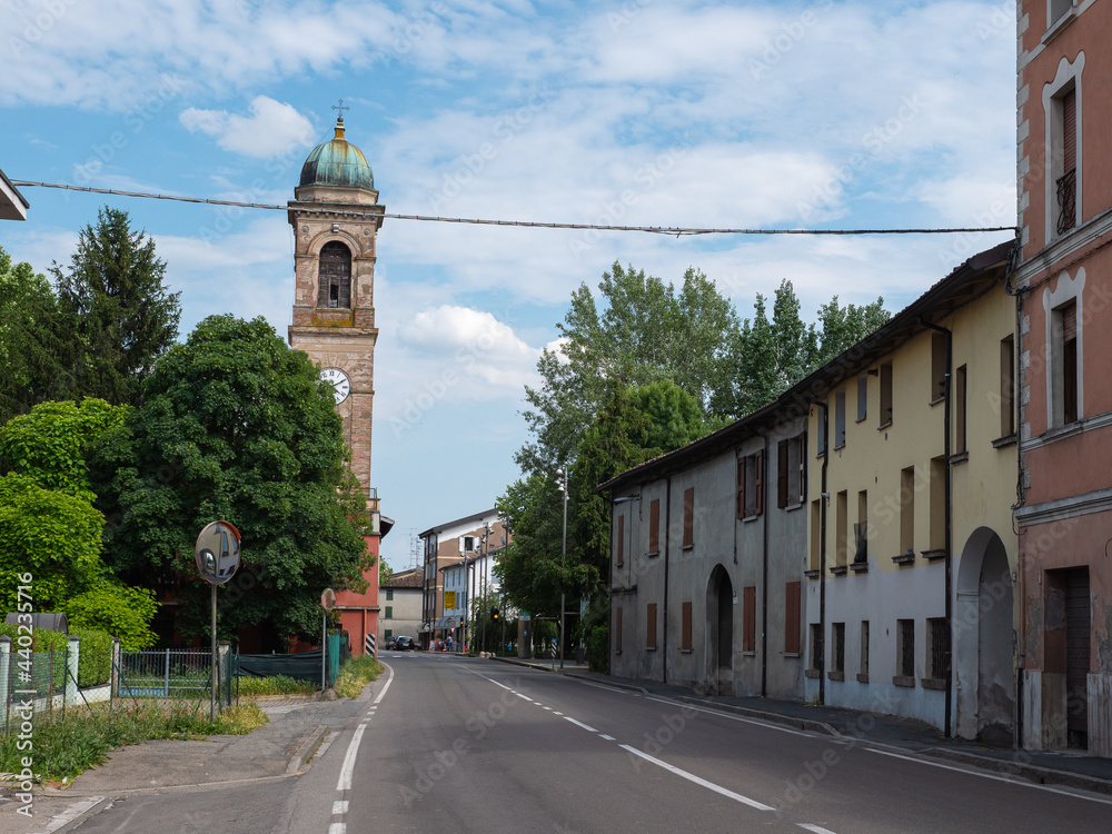 View of the via Emilia Road with Bell Tower of the Church of San Giacomo Apostolo in Cadè in the province of Reggio nell'Emilia, Italy