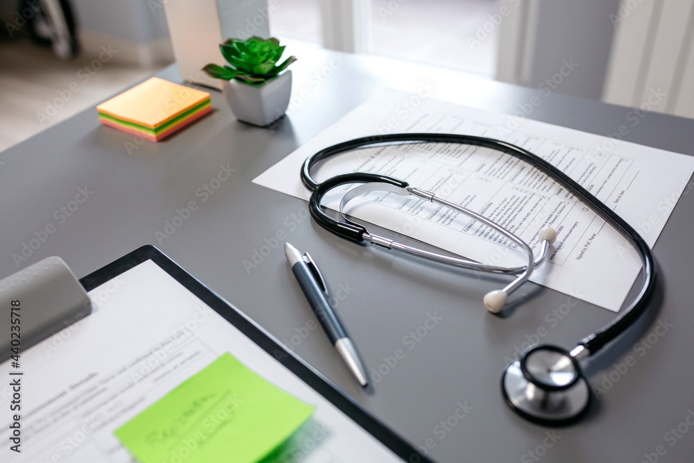 Doctor desk with stethoscope and medical documents Doctor desk with stethoscope and medical documents