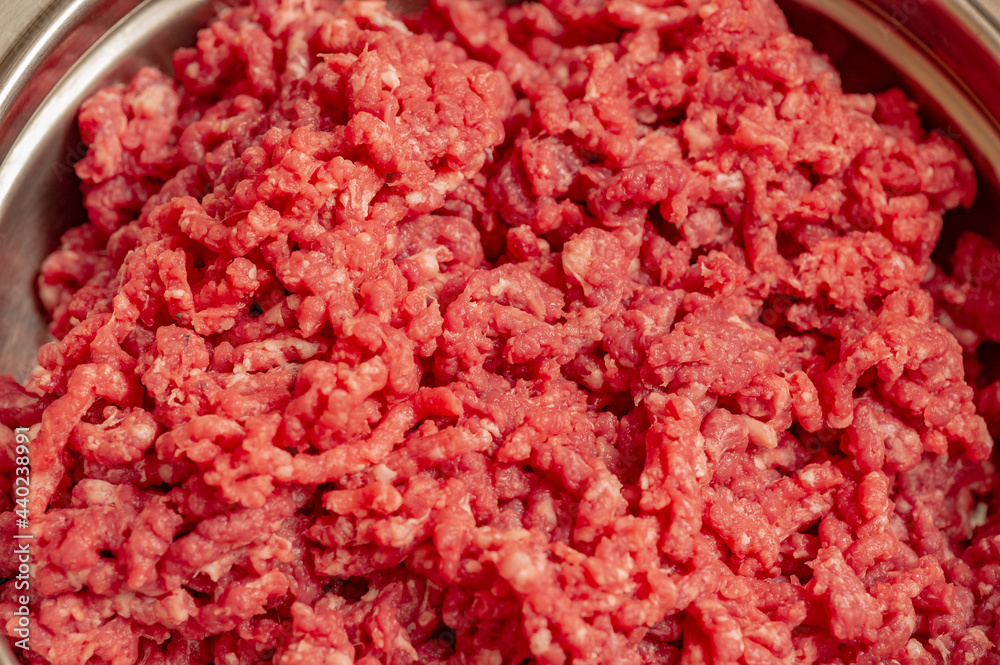 Minced beef close-up in a metal plate. Minced cutlets cooking for dinner. beef, grinder, raw, food, meat, cooking. Minced beef close-up in a metal plate. Minced cutlets cooking for dinner. beef, grinder, raw, food, meat, cooking.