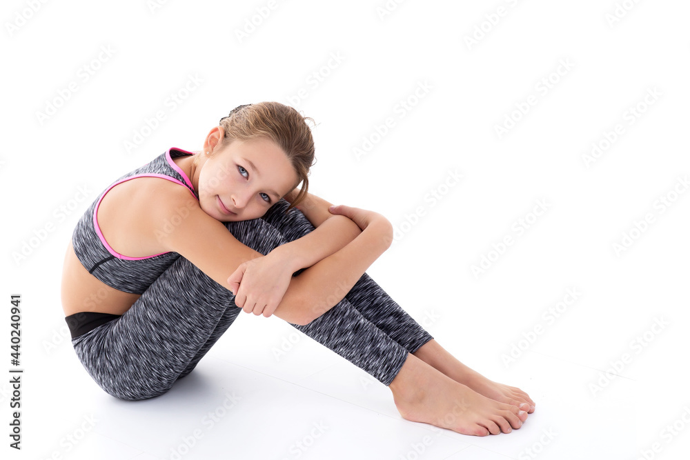 Teen girl posing on the floor in the studio. Teen girl posing on the floor in the studio.