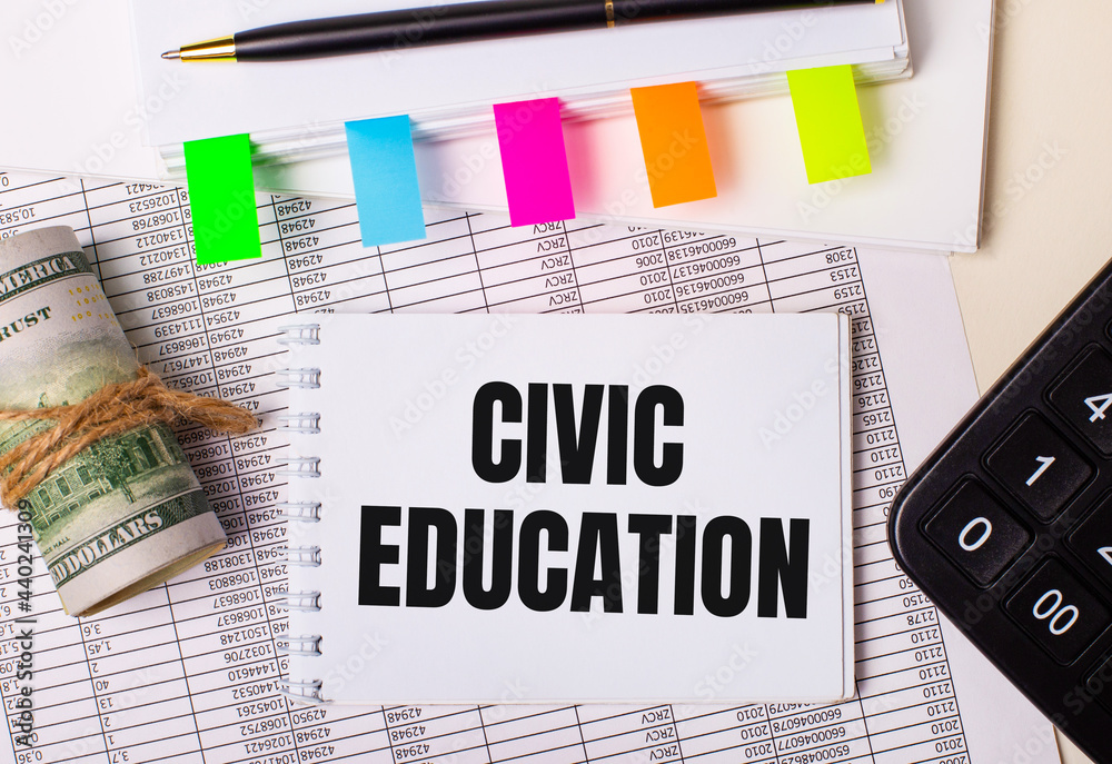 The desktop has reports, notepads, calculator, pen, cash and notepad with colorful stickers and the text CIVIC EDUCATION