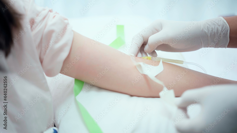 Close up introduction of a needle for the introduction of a medicinal solution.