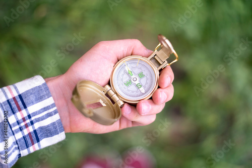 tourist hand holding a compass and searching the way to destination