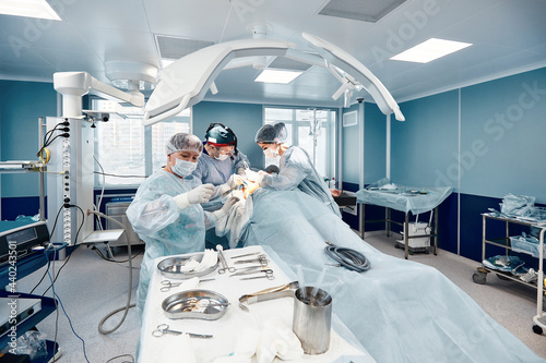 A modern operating room, surgeons and doctors doing an oncological operation, modern medicine, a light operating unit.