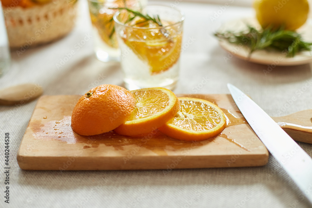Citrus and rosemary fresh lemonade in glass on a white table at home