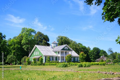 The old green beautifull house or mansion of P.A. Gannibal (a relative of A.S. Pushkin) in the Petrovskoe, Pushkinskie Gory, Family estate ancestors Alexander Pushkin's manor on a sunny summer day. photo