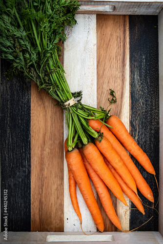 bunch of fresh carrots, vintage wooden texture background.
