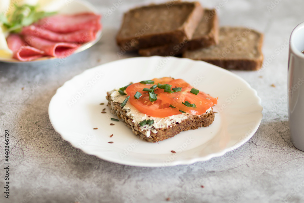 Cooked breakfast with coffee and sandwich. All this on a gray background Cooked breakfast with coffee and sandwich. All this on a gray background
