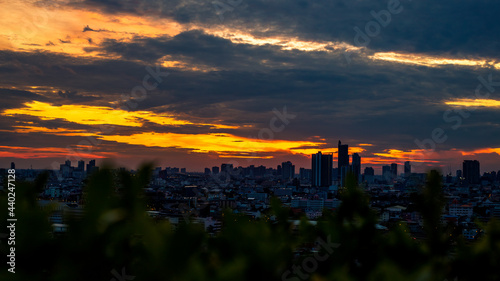 The high angle background of the city view with the secret light of the evening, blurring of night lights, showing the distribution of condominiums, dense homes in the capital community