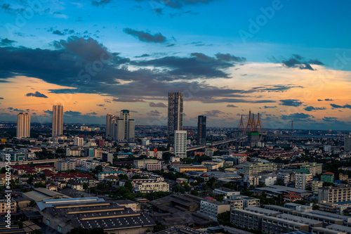 The high angle background of the city view with the secret light of the evening, blurring of night lights, showing the distribution of condominiums, dense homes in the capital community