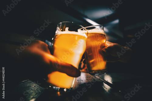 Closeup view of a two glass of beer in hand фототапет