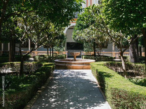 Andalusian patio with gardens around a fountain in the center