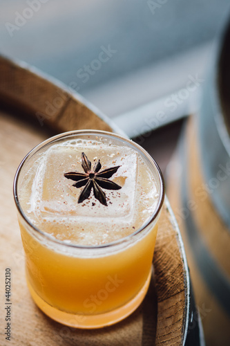 Slika na platnu autumnal apple cider cocktail with star anise garnish on wooden whiskey barrel