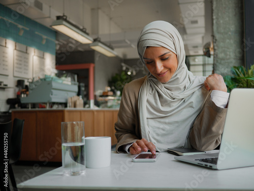 Muslim woman on remote working, online education or video conversation in caffe