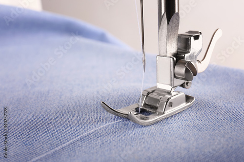 Closeup view of sewing machine with fabric