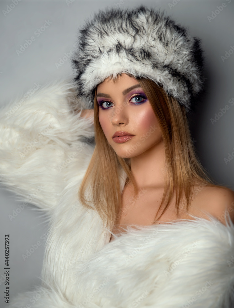 Young woman wearing a fur coat and fur hat Young woman wearing a fur coat and fur hat