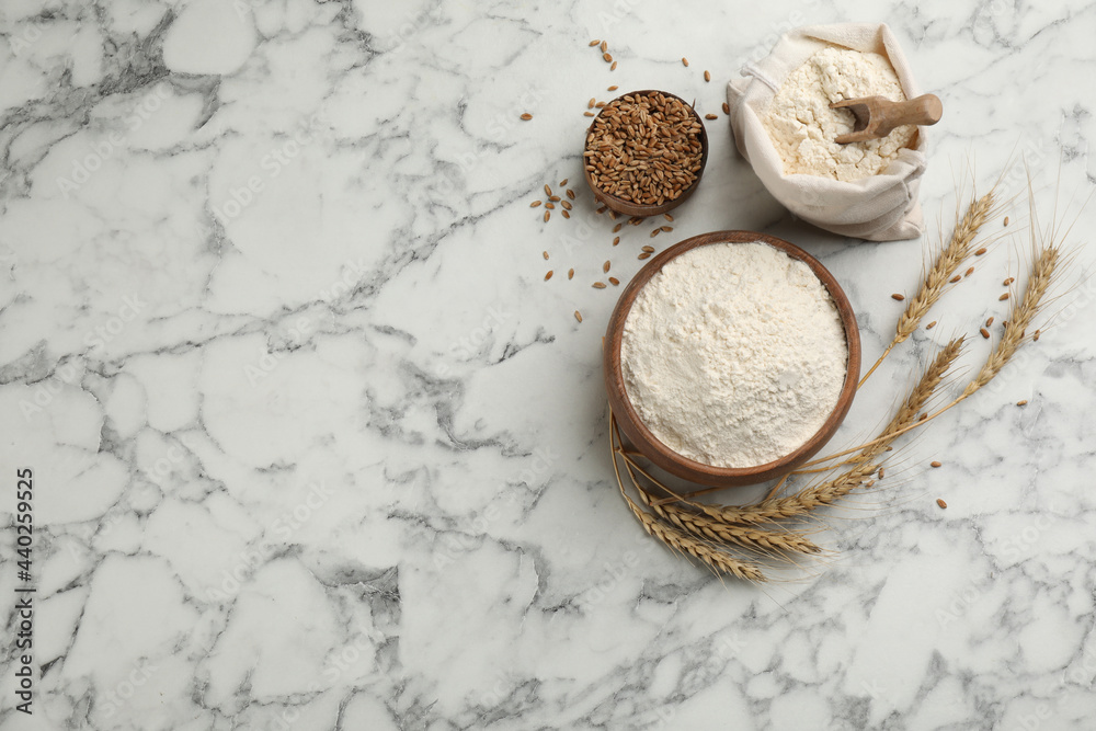 Flat lay composition with wheat flour on white marble table. Space for text Flat lay composition with wheat flour on white marble table. Space for text