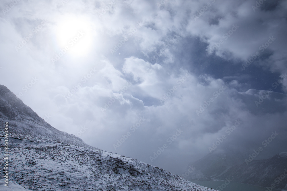 Snowing high altitude mountains on winter day Snowing high altitude mountains on winter day