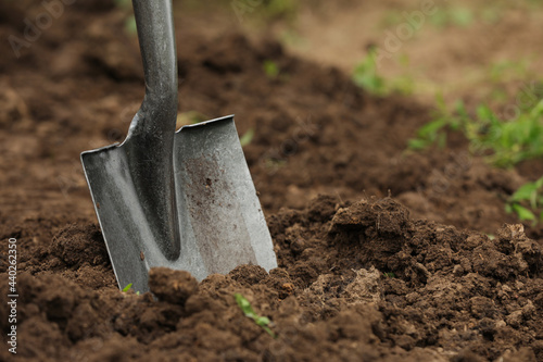 Fotografering Shovel in soil outdoors, space for text. Gardening tool