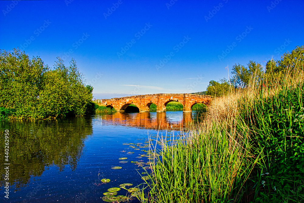 Fototapeta premium Eckington Bridge spanning the River Avon in the English county of Worcestershire, England. Eckington Bridge is a grade II listed bridge that was erected in the 1720's using red sandstone.