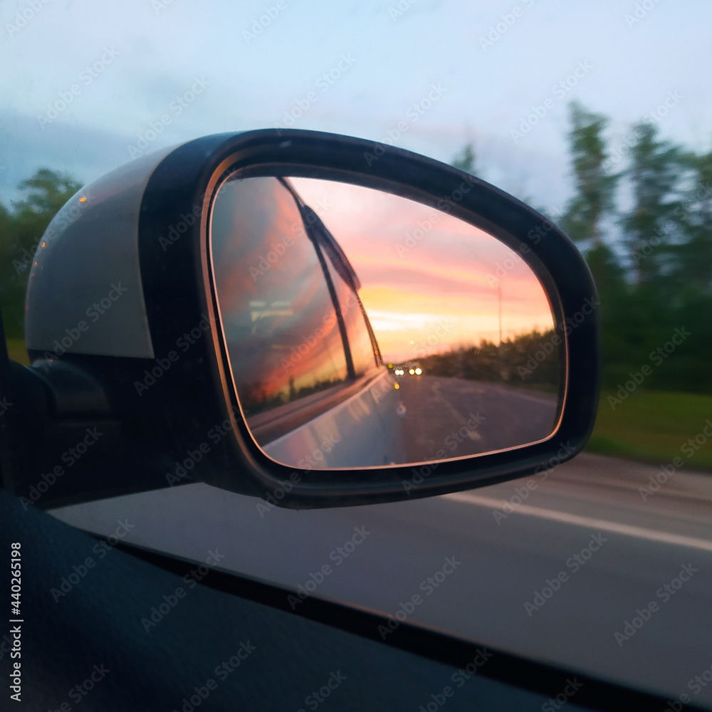 Beautiful sunset reflected in the car mirror