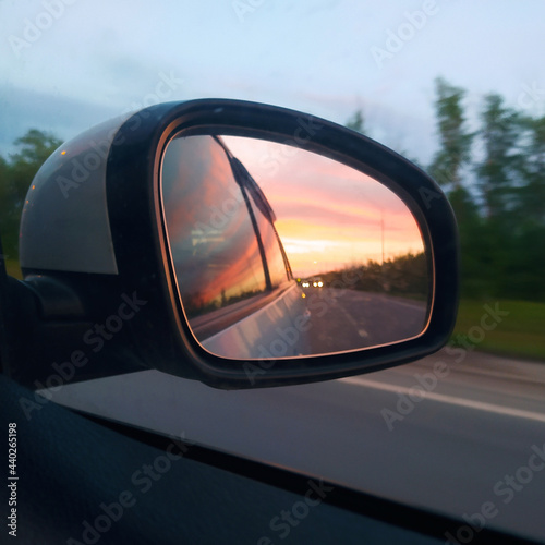 Beautiful sunset reflected in the car mirror