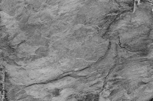 Black and white background. Gray rock texture. Grunge stone background. The texture of the mountains. Close-up. Grunge banner with volumetric rock texture