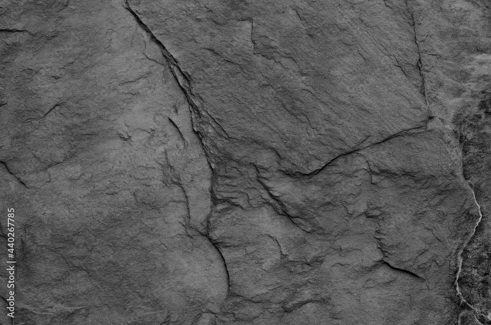 Black and white background. Gray rock texture. Grunge stone background. The texture of the mountains. Close-up. Grunge banner with volumetric rock texture