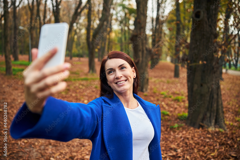 Positive delighted female person taking selfie photo Positive delighted female person taking selfie photo
