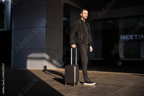 Confident traveler walking with his suitcase alone © Viacheslav Yakobchuk