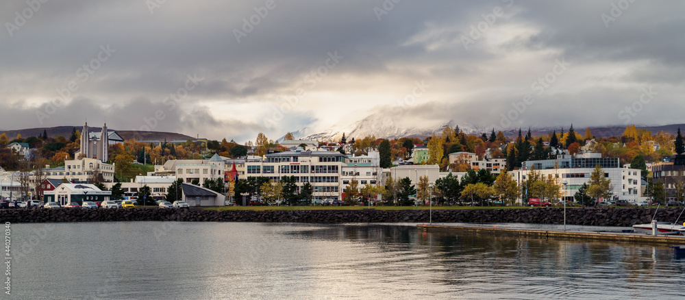 A view of the city of Akureyri as the snow mountain was unveiled from the ominous cloud in the background