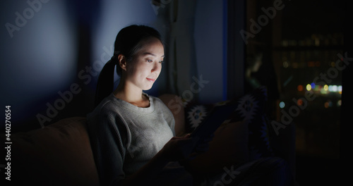 Woman work on tablet computer at home in the evening