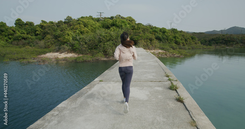 Woman run on the stone bridge