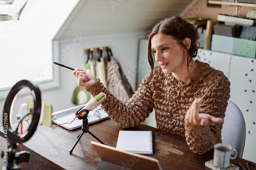 Woman sitting at desk and recording video