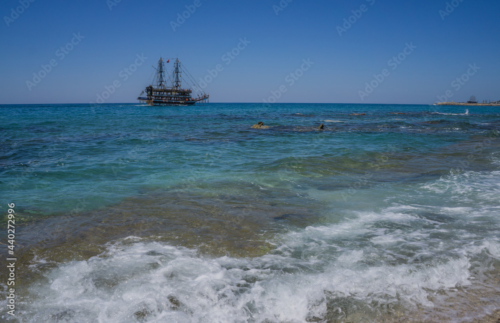 Alanya. Turkey. June 2, 2012; A masted pleasure ship on the horizon of the blue sea.
