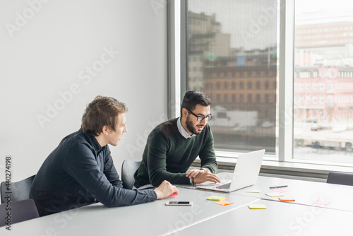 Coworkers talking in board room
